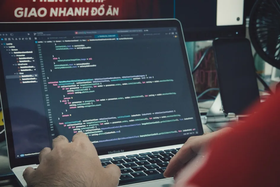 a man sitting in front of a laptop computer