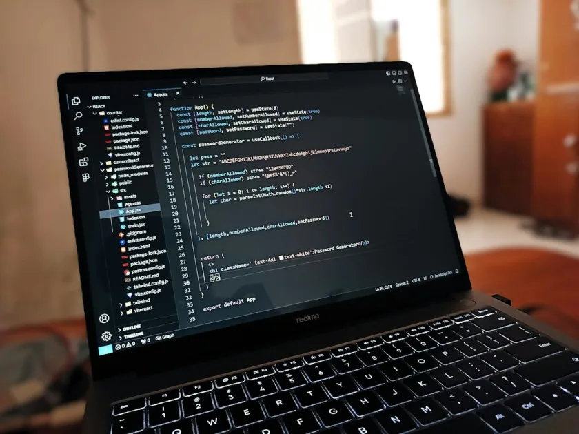 A laptop computer sitting on top of a wooden desk