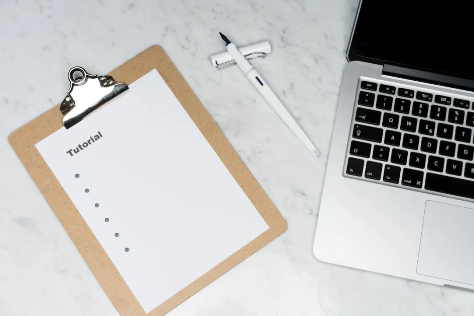 white paper on brown folder beside silver key
