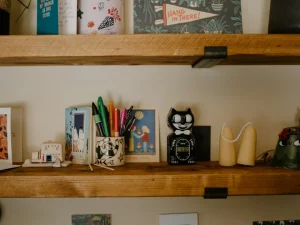 Desk shelves with various decorative items and art supplies